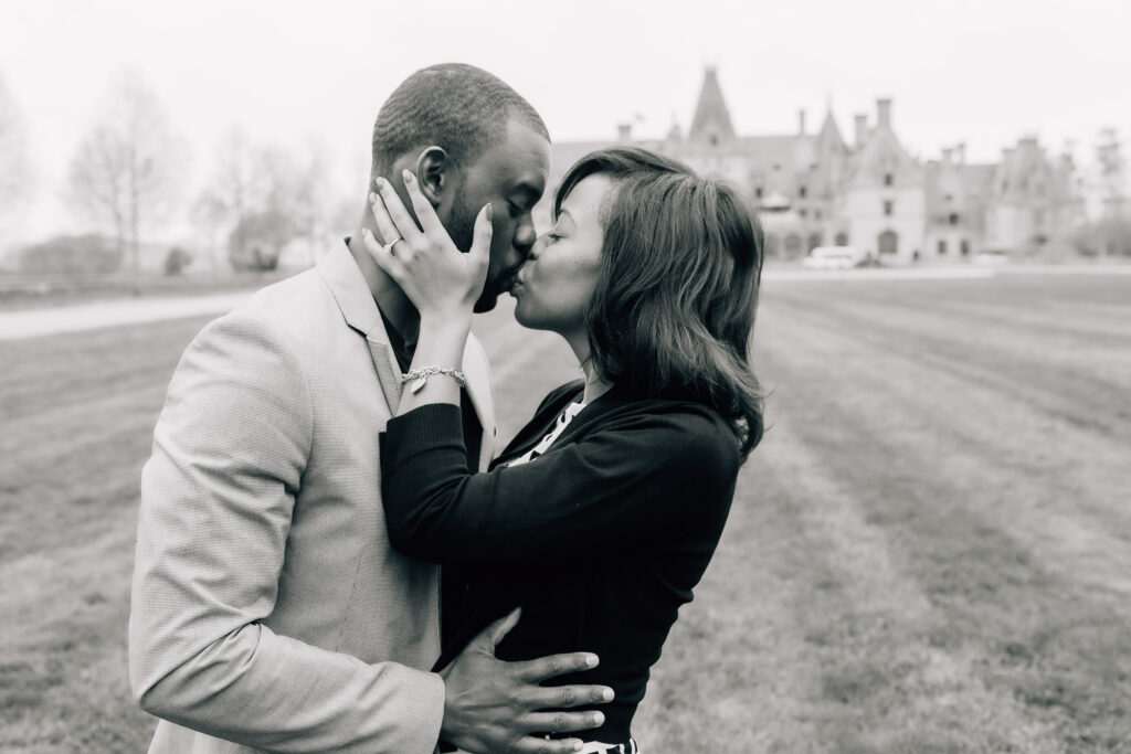 black and white closeup of a couple kissing after he proposed to her at the biltmore