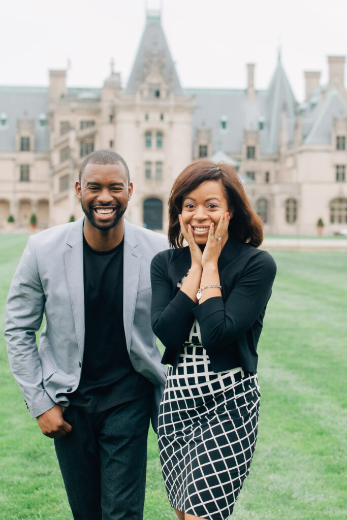 woman grabs her face in surprise after her partner proposed at the biltmore estate in asheville, nc