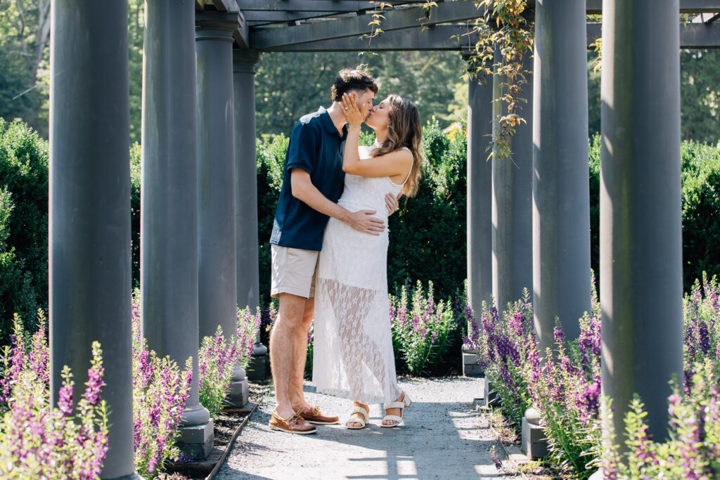 couple kisses after their proposal at reynolda gardens in winston-salem, nc