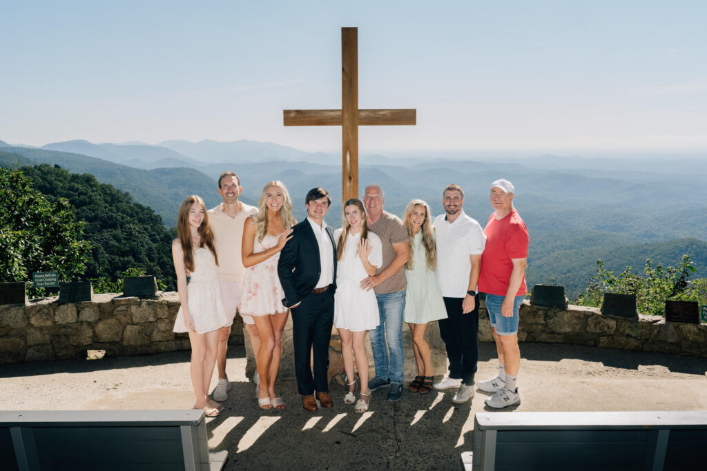family members celebrate with a newly engaged couple during their surprise propsal at symmes chapel in sc