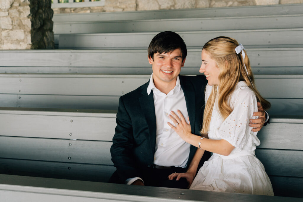 man smiles as her girlfriend looks at him with a big smile after their proposal at pretty place chapel